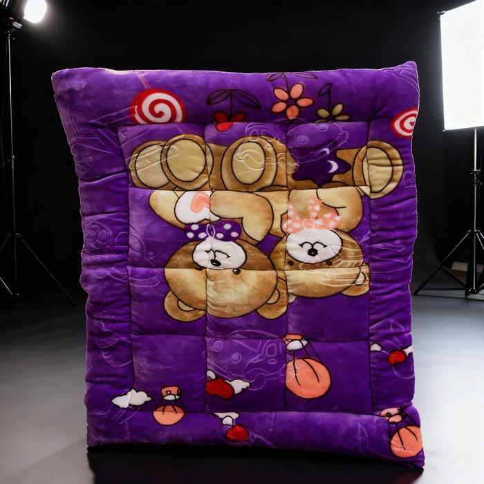 Purple quilt with cartoon bear design on a dark background