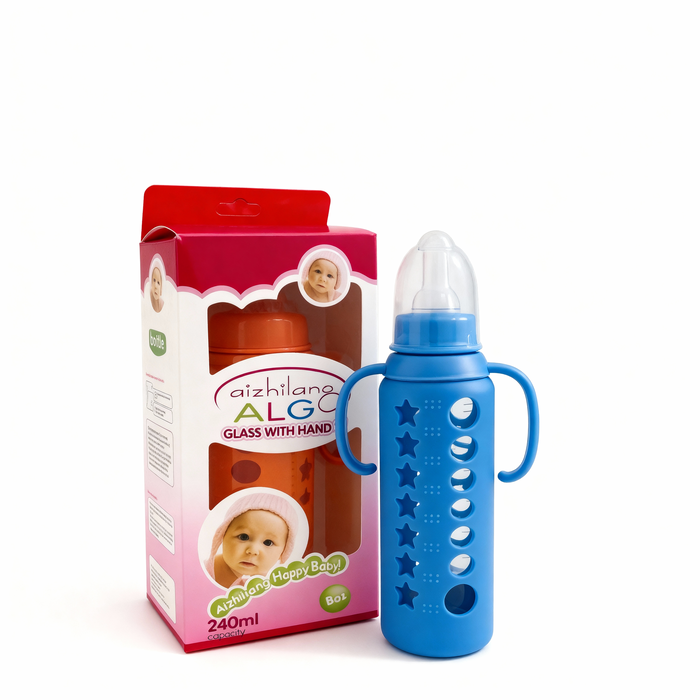 Blue baby bottle with star patterns and handle next to its packaging on a white background