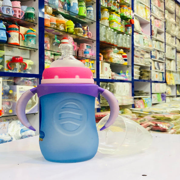 Blue baby bottle with purple handle on a shelf in a store