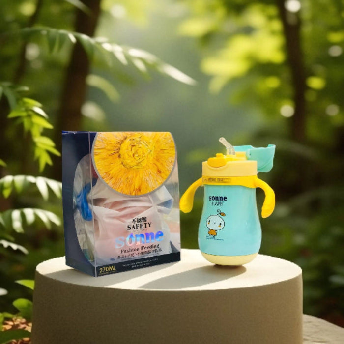Children's blue and yellow sippy cup with packaging on a natural background